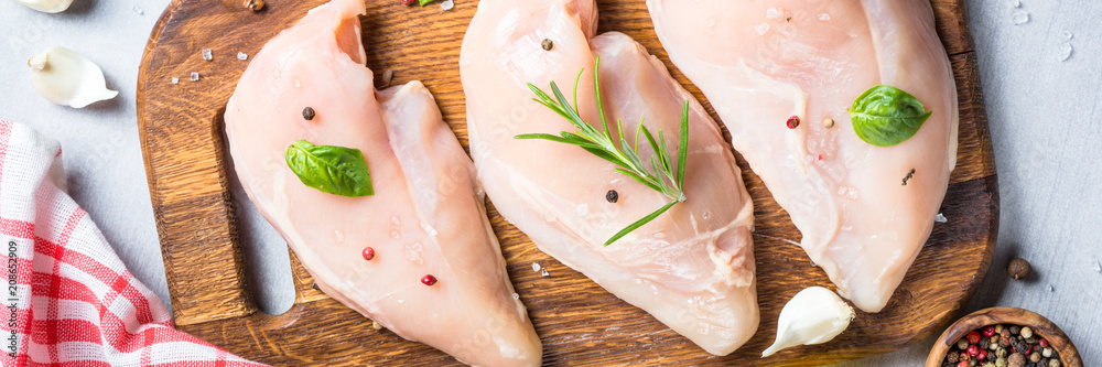 Raw chicken fillet with spices and herbs top view. Raw chicken fillet with spices and herbs top view.