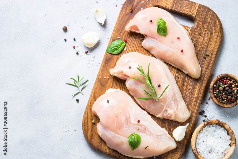 Raw chicken fillet with spices and herbs top view. Raw chicken fillet with spices and herbs top view.