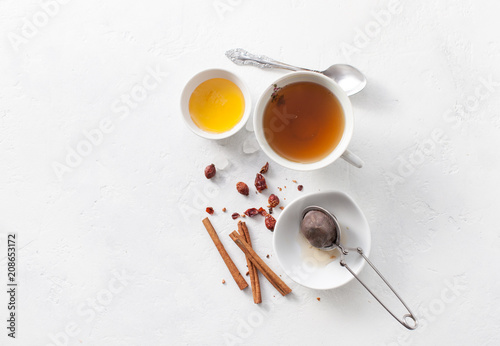 Tea in a Cup with cinnamon, honey and rosehip. Copy space text