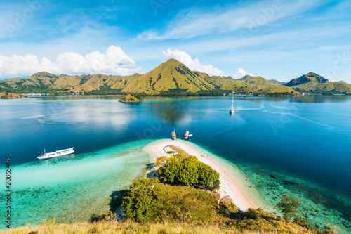 Top view of 'Kelor Island' in an afternoon before sunset with turquoise sea and tourist boats, Komodo Island (Komodo National Park), Labuan Bajo, Flores, Indonesia photo