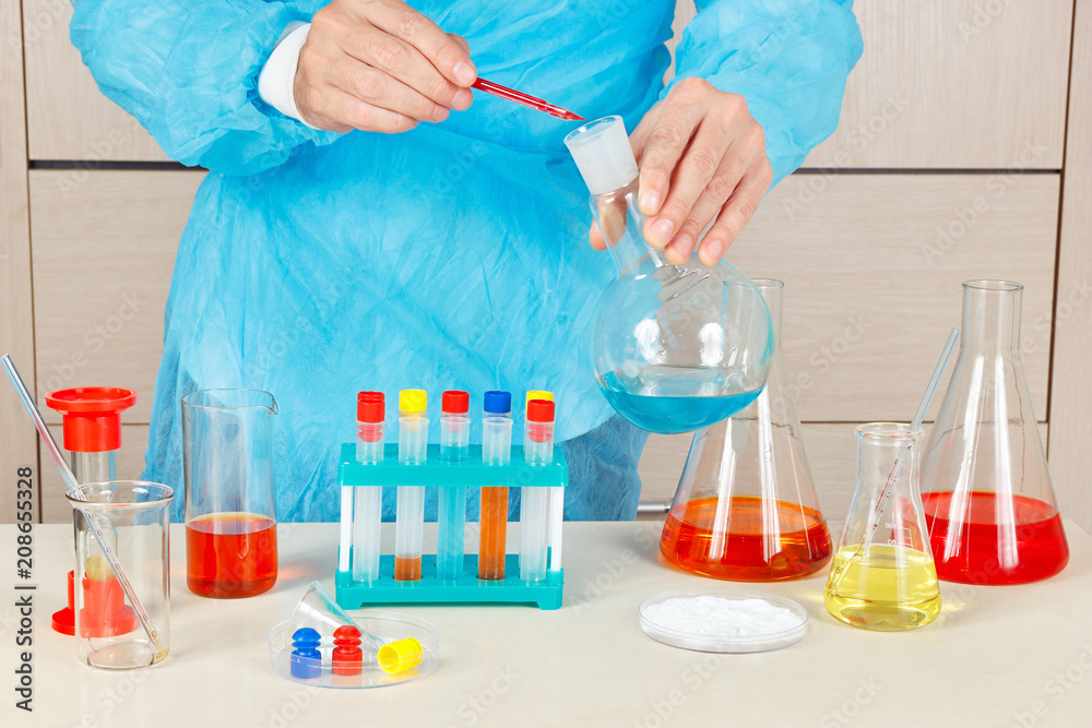 Researcher is conducting chemical experiments in the laboratory Researcher is conducting chemical experiments in the laboratory