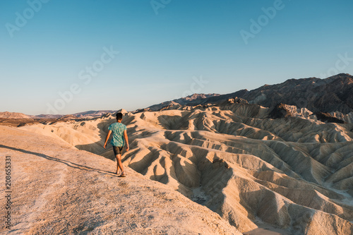 Man walks on the desert in the lowest point on earth in Death valley, USA, West Coast