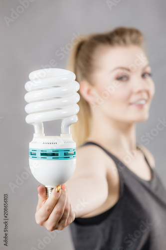 Woman holding eco modern light bulb