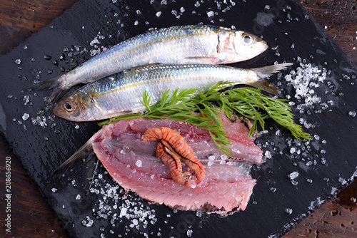 Plate with sardines cherry tomatoes and aromatic herbs   photo