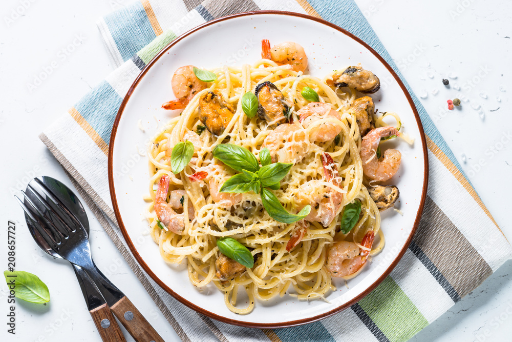 Pasta spaghetti with seafood and cream sauce on white. Pasta spaghetti with seafood and cream sauce on white.