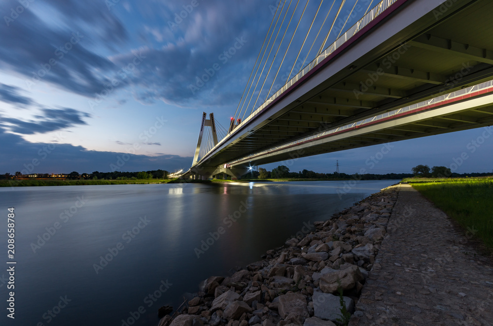 modern bridge over Vistula river, Krakow, Poland, illuminated in the night