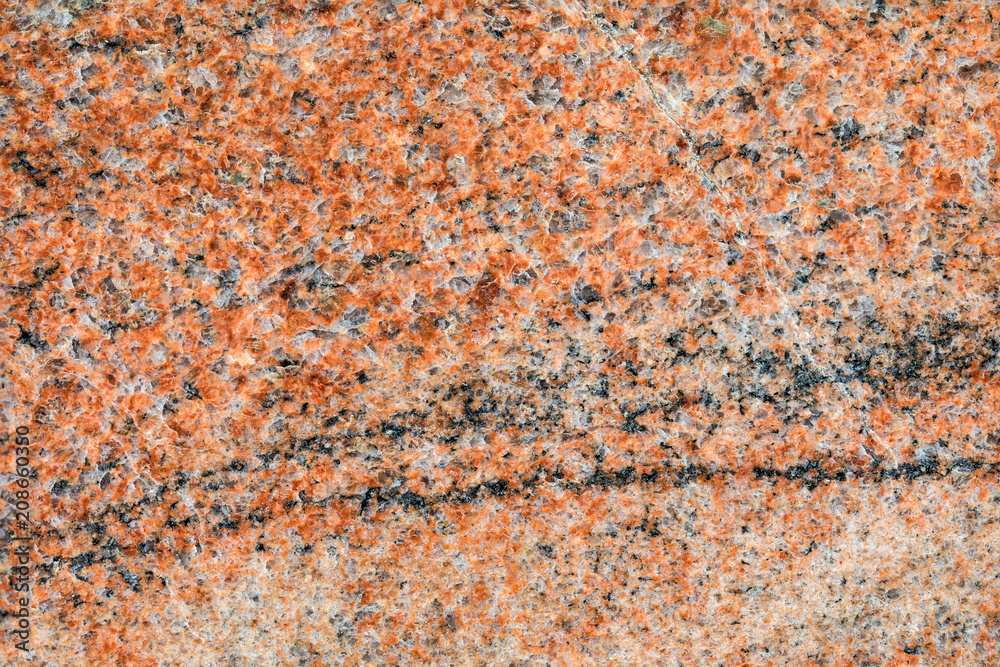 Granite, basalt or marble stone crystal texture of polished gravestone. The macro shot is made by means of stacking technology