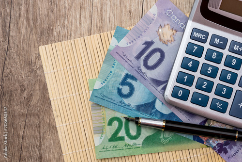 Canadian dollars on wooden desk, macro . photo