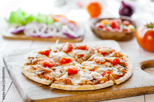 hot fresh homemade traditional italian pizza on wooden table. wallpaper for pizzeria and cooking food concept. closeup