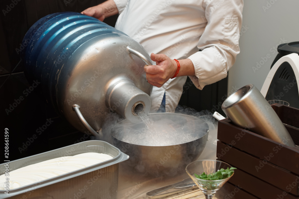 Chef is pouring liquid nitrogen from a large Dewar flask