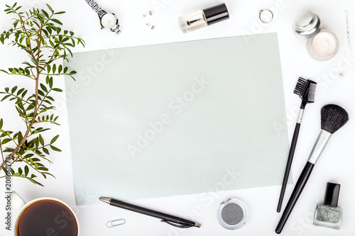 beauty and fashion blog or online shop concept. professional decorative cosmetics, makeup tools, accessory and coffee mug on white background with copy space for text. flat lay composition, top view
