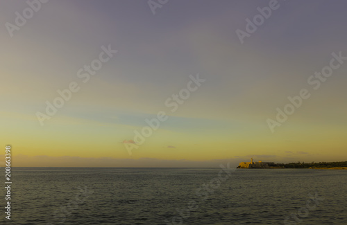 Sunset over Malecon and Atlantic Ocean with Morro Castle in background - Havana, Cuba 