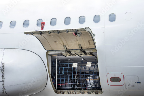 Luggage compartment and cargo section in the airplane open on inspection, with bags and luggage of passengers.