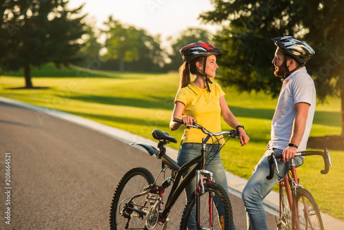 Couple of students on romantic date. Happy young adult couple in love spending time riding bikes. Couple in love. People enjoying sunny day.