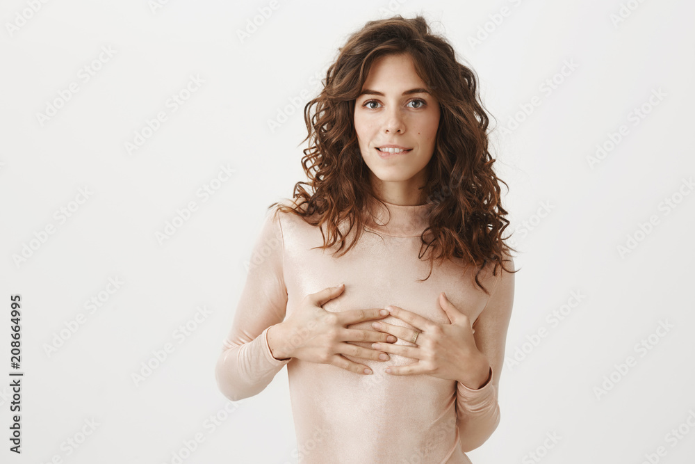 Curly-haired woman showing her nice tits on camera