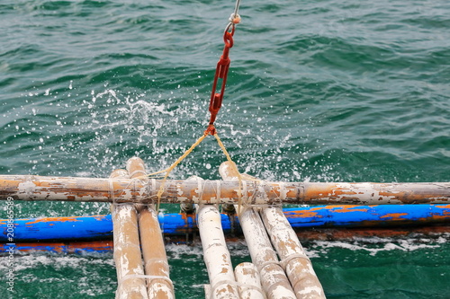 Bamboo outrigger projecting from a Filipino bangka boat-N.Bays Bay-Negros Oriental-Philippines.0527