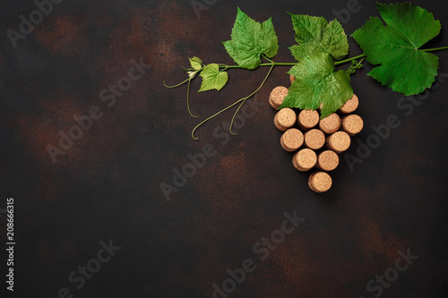 Grape bunch of cork with leaves on rusty background