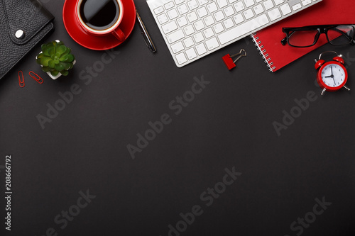 black background red coffee cup note pad alarm clock flower diary scores keyboard empty space desktop