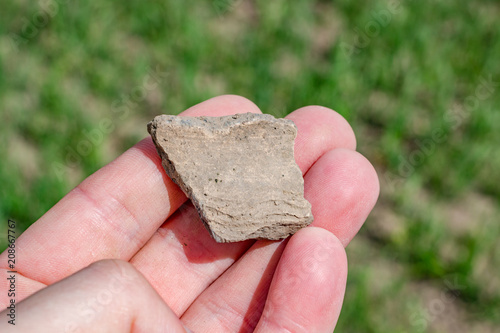 A fragment of a ceramic vessel found in a field