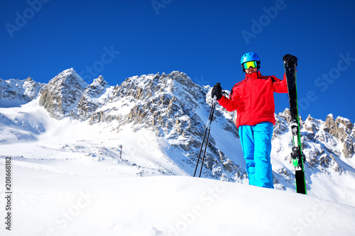 Young happy skier ready for skiing on the top of Alps.