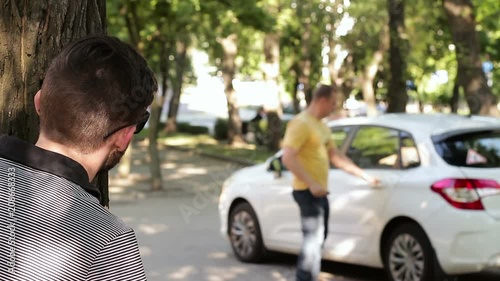 A scene of infidelity in a relationship. Girl and lover leaving the car photo