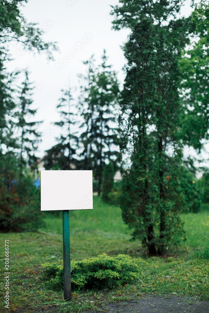 White plate in the park for inscriptions