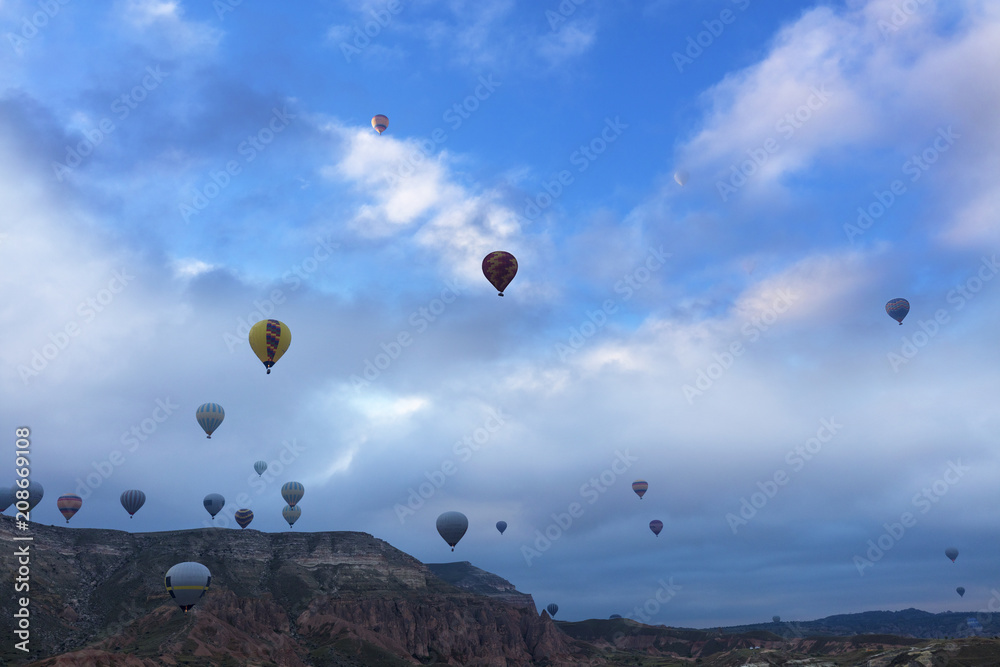 Dozens of balloons fly over the valleys in Cappadocia Dozens of balloons fly over the valleys in Cappadocia
