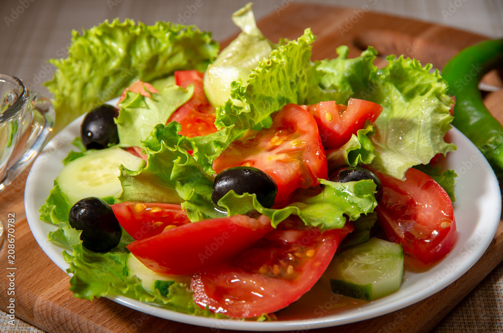 Fresh salad of tomatoes, olives and cucumbers Fresh salad of tomatoes, olives and cucumbers