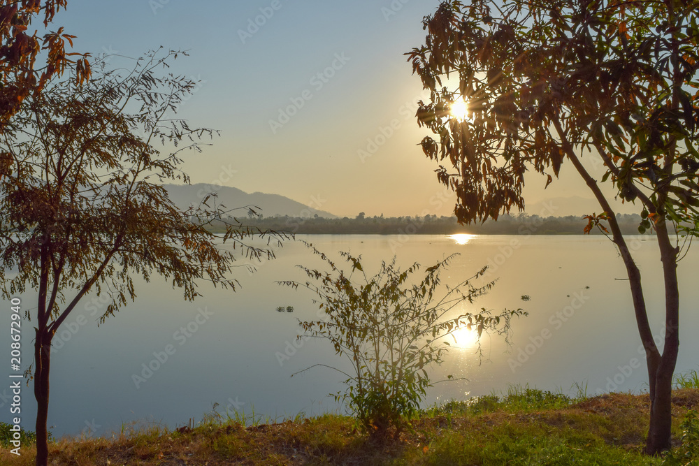 Sun shining over river in Malawi, Africa