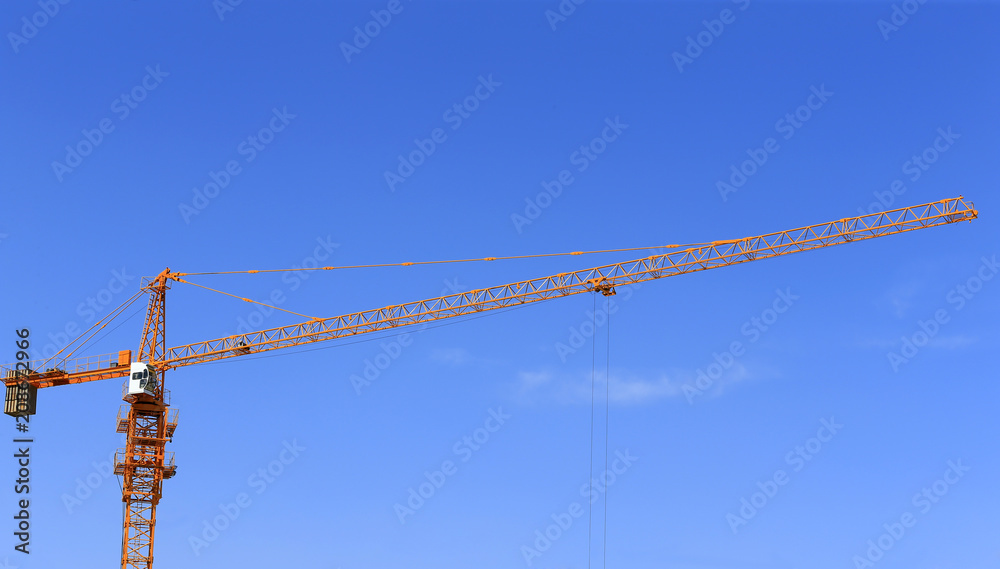 The crane is working at the construction site The crane is working at the construction site