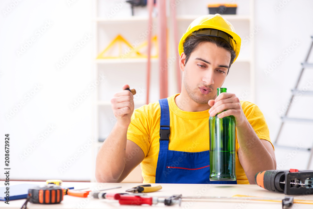 Drunk engineer working in the workshop Drunk engineer working in the workshop