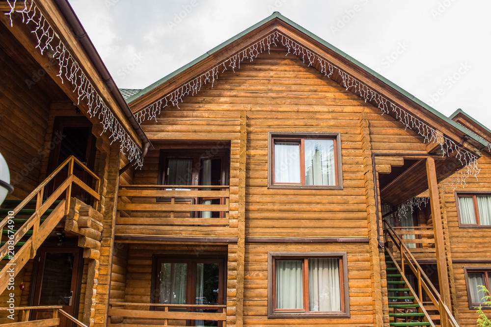 wooden cottages facade with empty white space on sky for copy or text