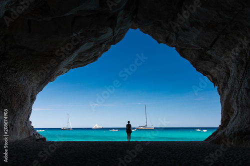 Woman inside a cave at Cala Luna beach © A. Emson