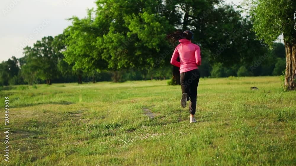 A morning jog in the Park near the pond in the Sunny rays of dawn, the girl is preparing to Mariano and lead a healthy lifestyle A morning jog in the Park near the pond in the Sunny rays of dawn, the girl is preparing to Mariano and lead a healthy lifestyle