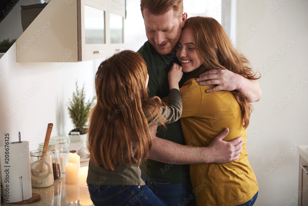 We missed you. Smiling female embracing husband while little kid is touching them. They are happy and delighted to be together We missed you. Smiling female embracing husband while little kid is touching them. They are happy and delighted to be together