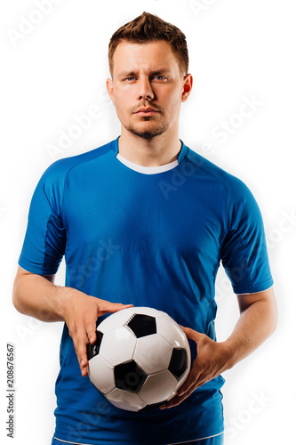Young handsome football player holds in hands soccer ball posing on white isolated.