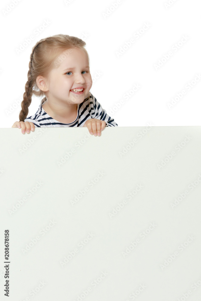 A little girl is looking from behind an empty banner. A little girl is looking from behind an empty banner.