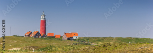 Panorama of the red lighthouse and houses on Texel island, The Netherlands