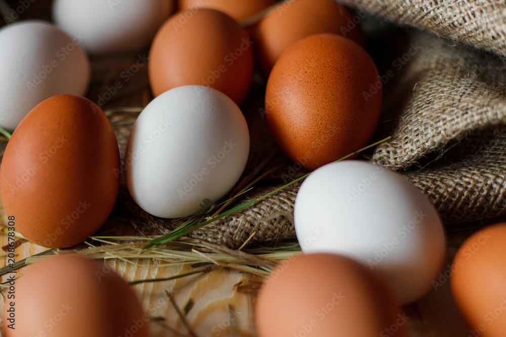 Fresh, raw eggs lie on the grass. Wood background. Texture of burlap. Organic background. Healthy eating. Easter composition Fresh, raw eggs lie on the grass. Wood background. Texture of burlap. Organic background. Healthy eating. Easter composition