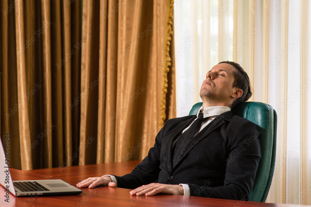 Tired businessman resting at a table Tired businessman resting at a table