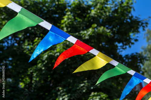 Colorful triangular flags of decorated celebrate outdoor party sunlight photo