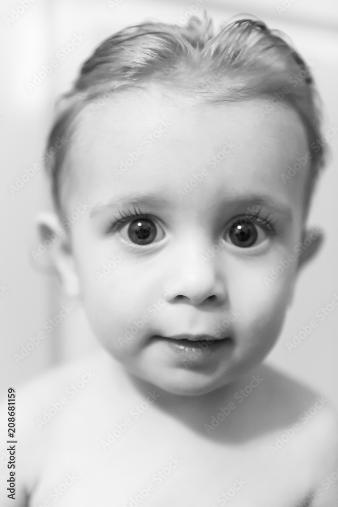 Toddler with big brown eyes and hair slicked back Toddler with big brown eyes and hair slicked back