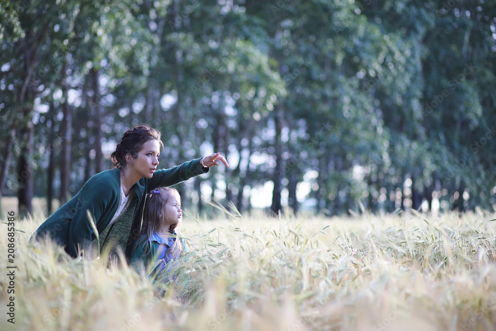 A young mother walk in wheat fields A young mother walk in wheat fields