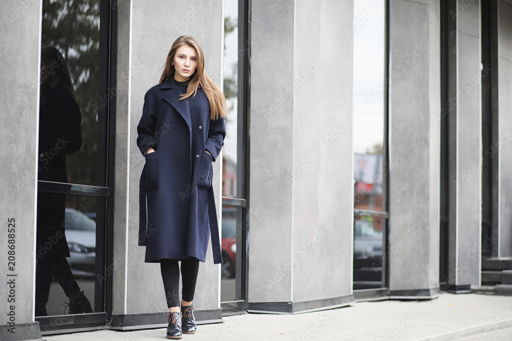 Beautiful girl in a coat in business downtown Beautiful girl in a coat in business downtown
