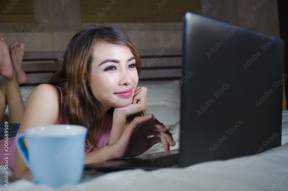beautiful and happy student woman enjoying on bed with laptop co beautiful and happy student woman enjoying on bed with laptop co