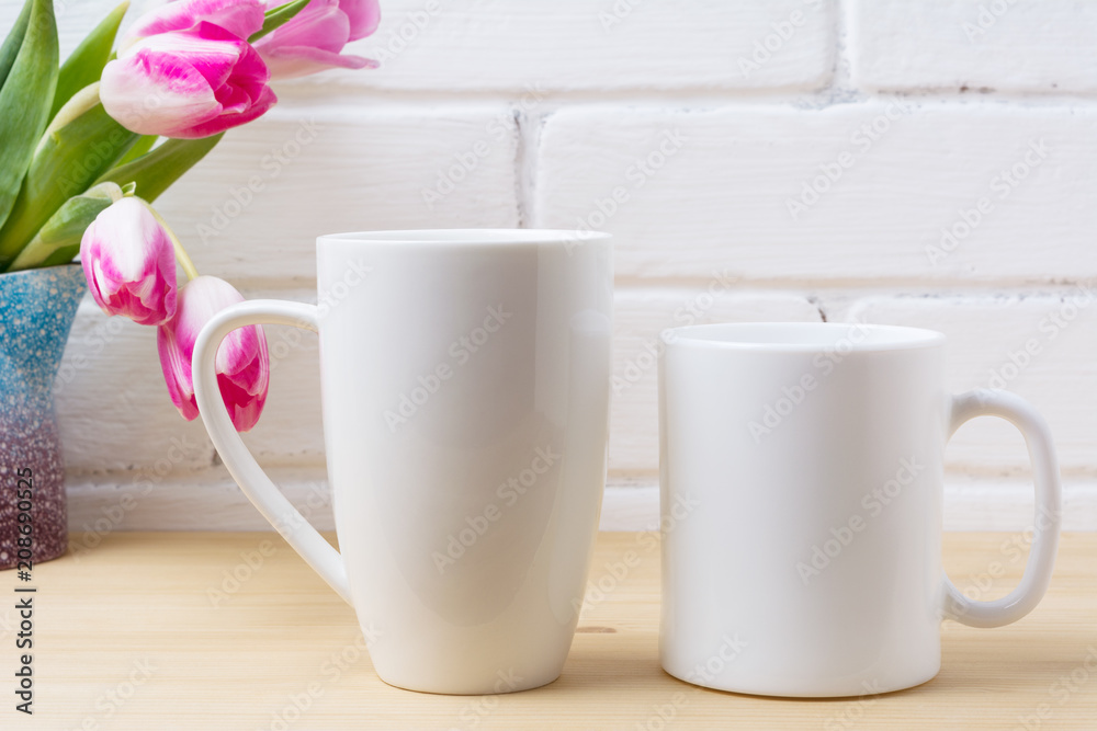 Obraz premium White coffee and cappuccino mug mockup with magenta tulip