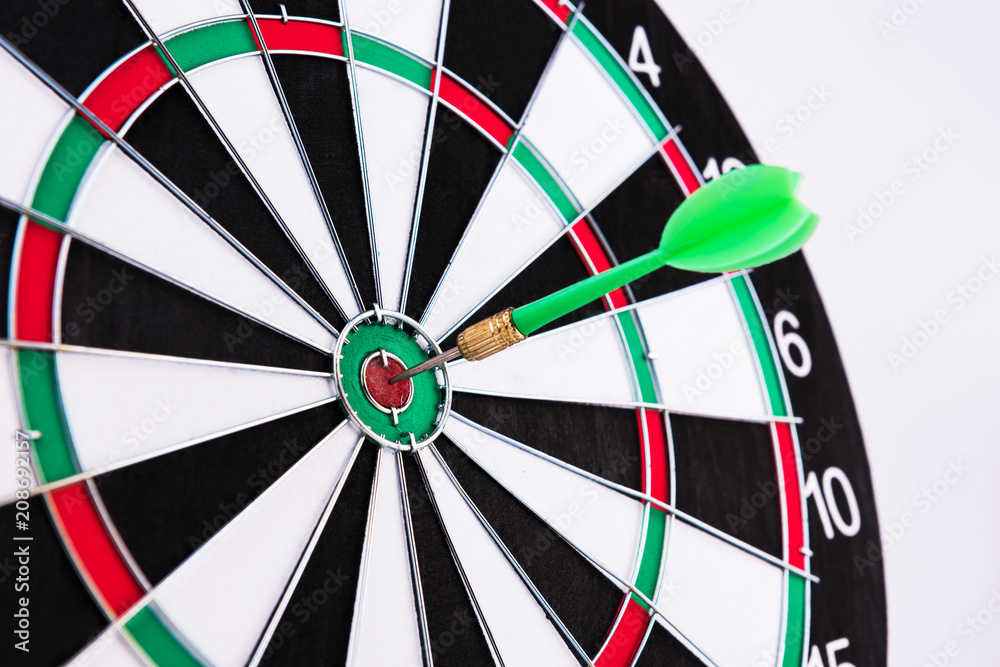 On the Target. Green dart hitting the target. On the Target. Green dart hitting the target.