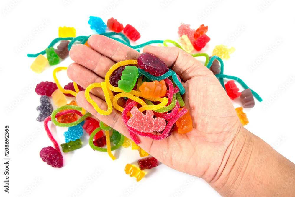 Obraz premium Jelly candy in hand isolated on white background