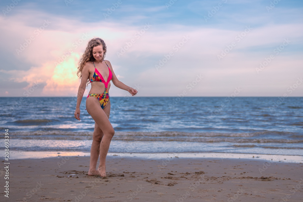 Happy woman with long blonde curly hair on the beach with enjoying and refreshing, summer beach relaxing time concept. Happy woman with long blonde curly hair on the beach with enjoying and refreshing, summer beach relaxing time concept.