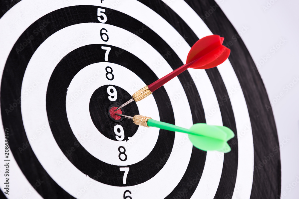 Dartboard with Darts Hitting the Bullseye Dartboard with Darts Hitting the Bullseye
